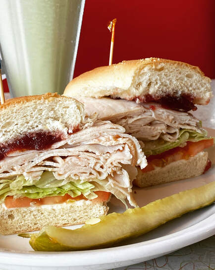 roasted turkey layers with cranberry on a hoagie roll